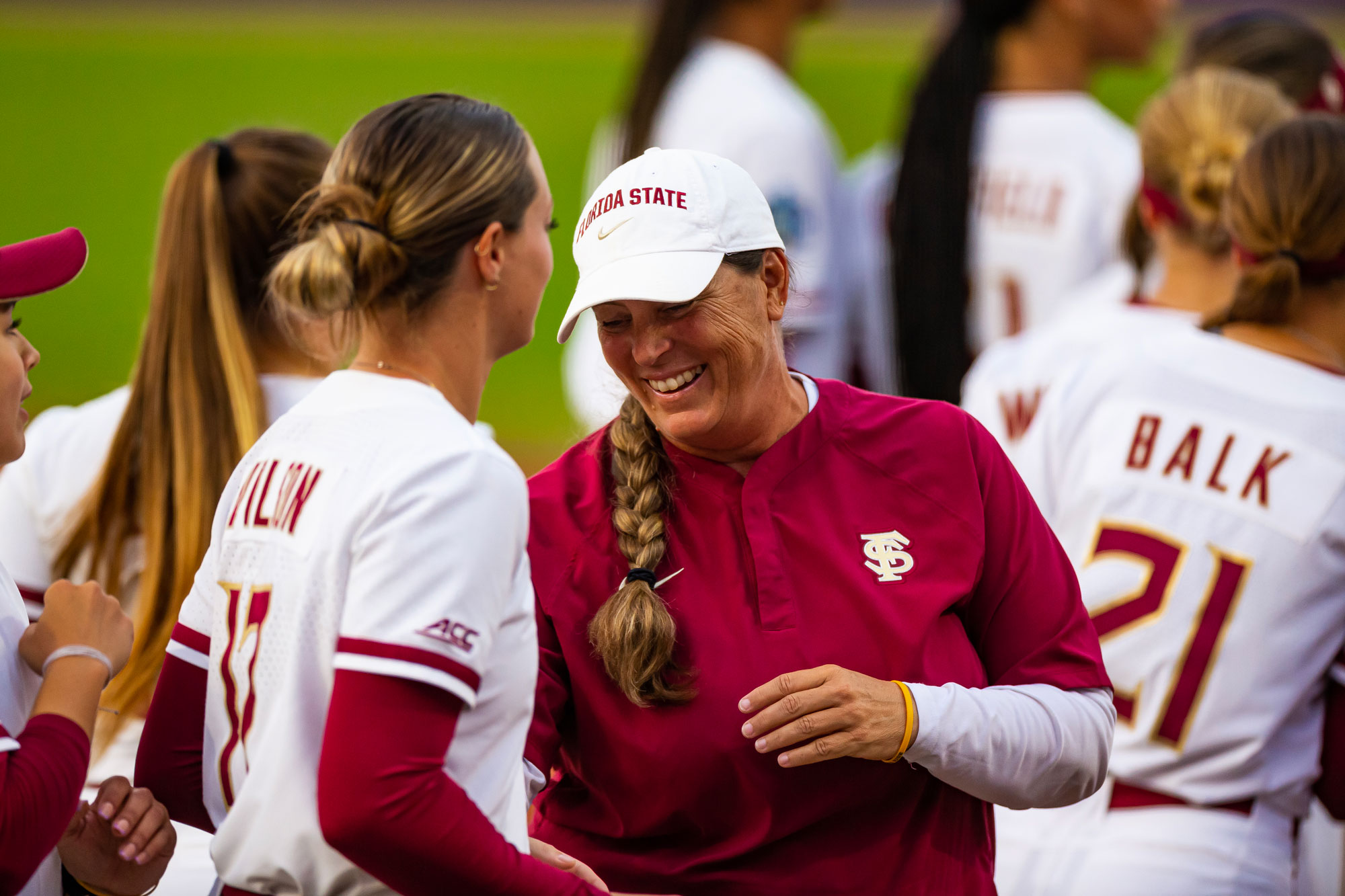 A photo of Coach Alameda and Kaley Mudge on a softball green