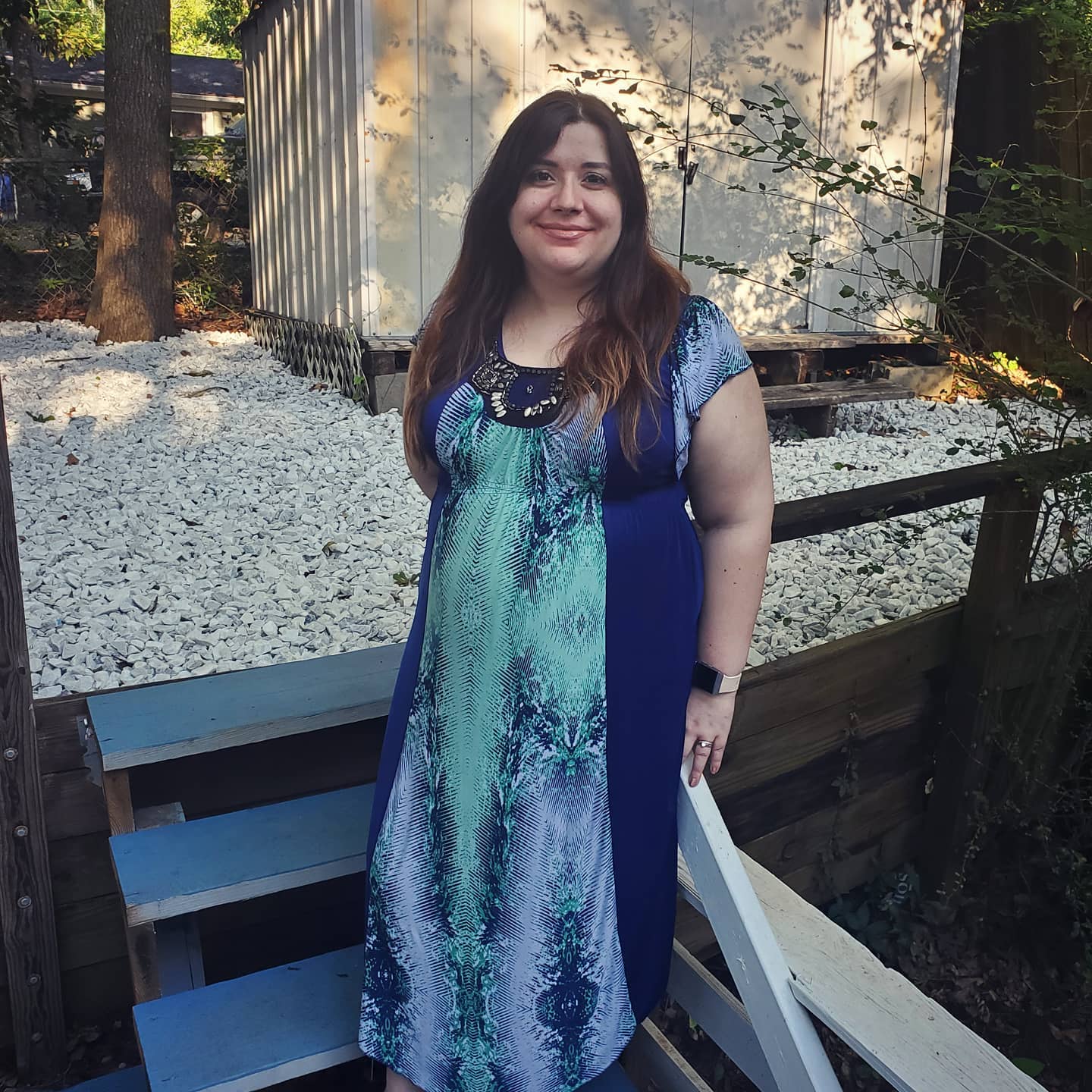 A photo of Angélique Stevens wearing a blue dress outdoors