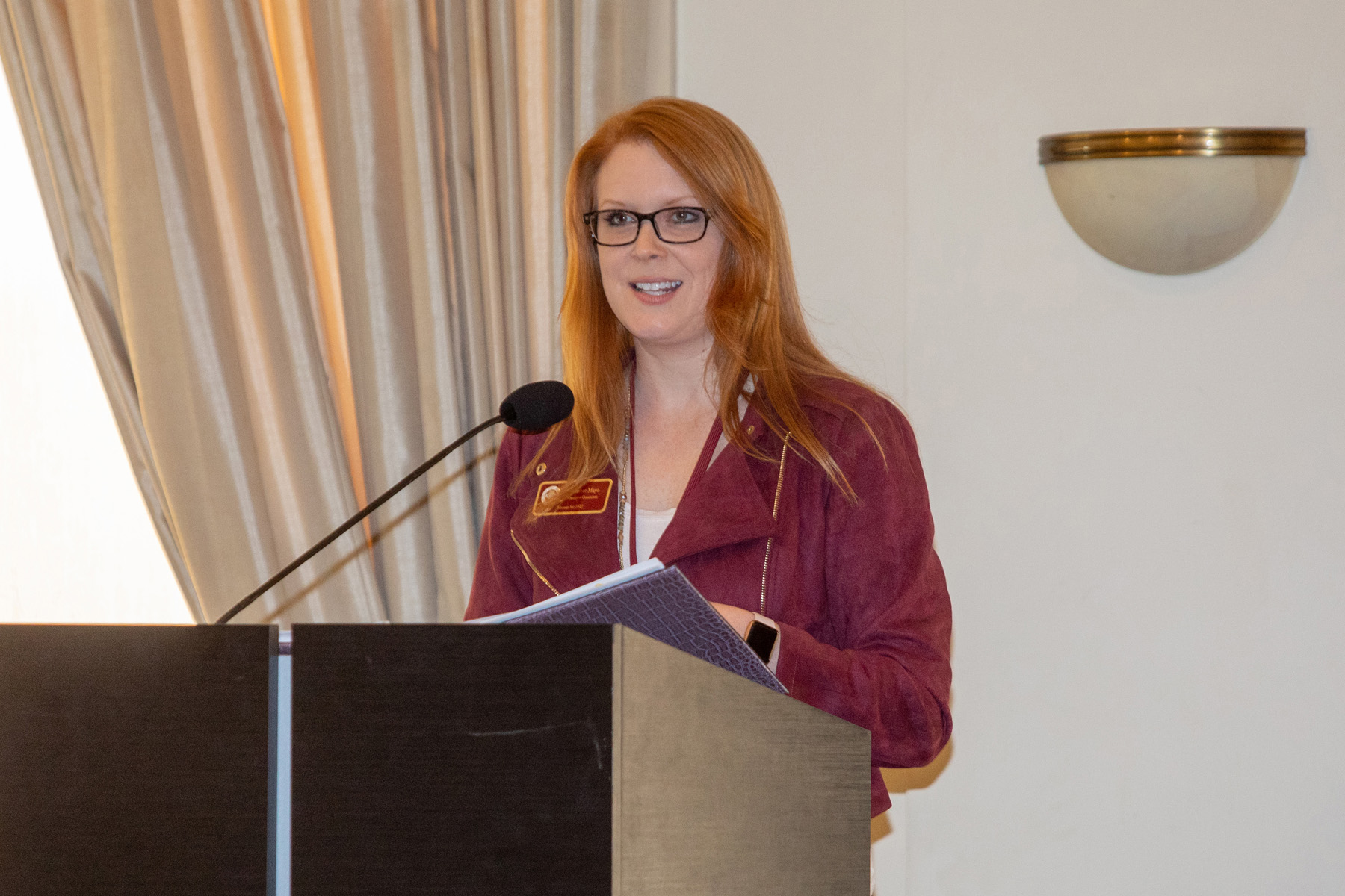 A woman standing at a podium speaking