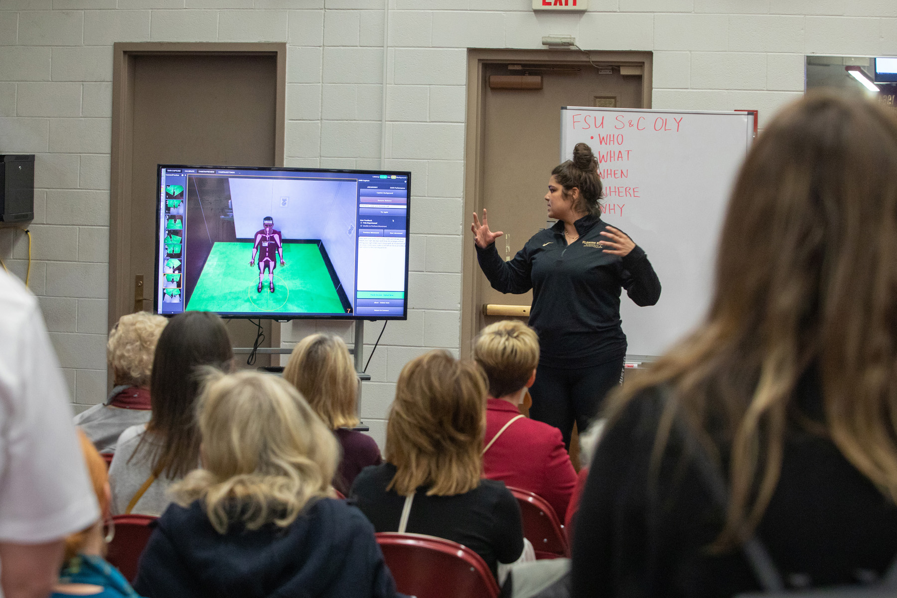 A young woman presenting to a class