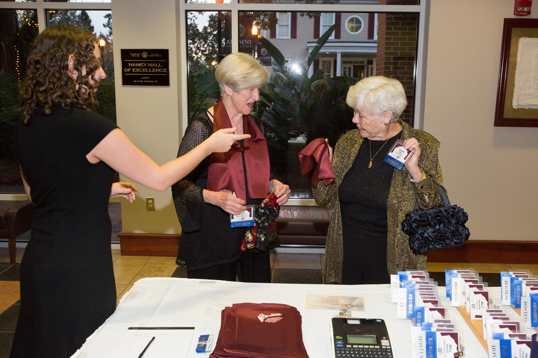 A photo of three women chatting at a table