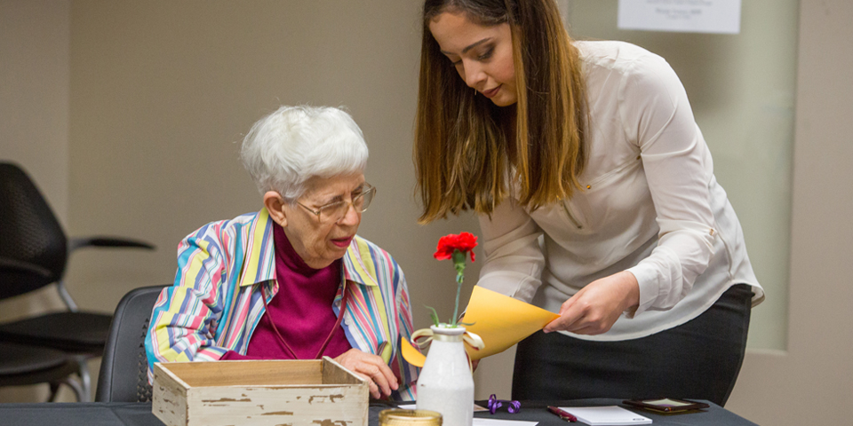 A young woman helping an elderly woman