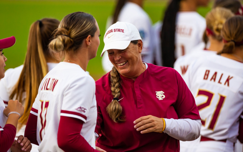 A photo of Coach Alameda and Kaley Mudge on a softball green