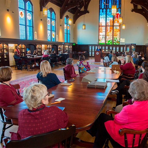 Women listening to speaker in the Werkmeister Room surrounded by stained glass